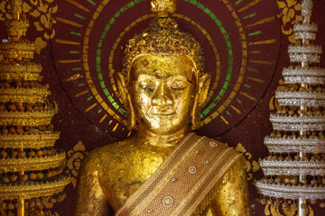 Fototapeta premium The Buddha inside a tiny room for worship in the temple.