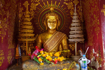 The Buddha inside a tiny room for worship in the temple.