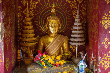 The Buddha inside a tiny room for worship in the temple.