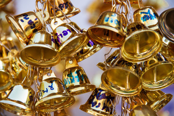 Muang, Phrae, Thailand - February 9, 2019: Many golden small bells hanging in the temple to pray for famous reputation like the sound of the bell.