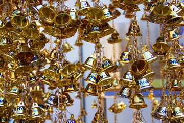 Muang, Phrae, Thailand - February 9, 2019: Many golden small bells hanging in the temple to pray for famous reputation like the sound of the bell.