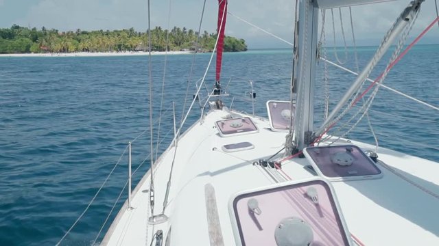 Slow Motion: Close-Up of Bow of Yacht on Blue Ocean with Island Ahead in El Limon, Dominican Republic