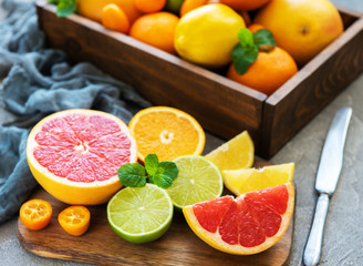box with citrus fresh fruits on a concrete background