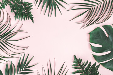 Summer composition. Tropical palm leaves on pastel pink background. Summer concept. Flat lay, top view, copy space