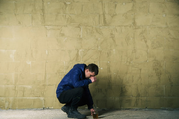 A disheveled man with alcohol in his hand.