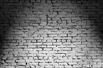Black and white brick wall lighted from above