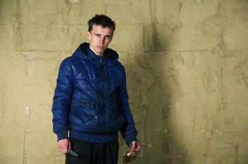 Obraz premium A disheveled man with alcohol in his hand.