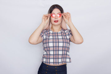 Blonde woman wearing sunglasses over white background
