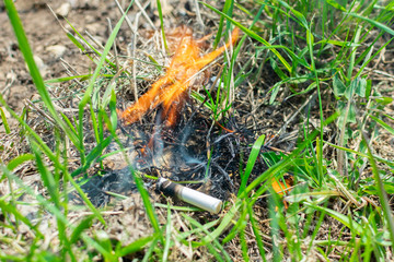 Cigarette causing a dangerous fire on the forest