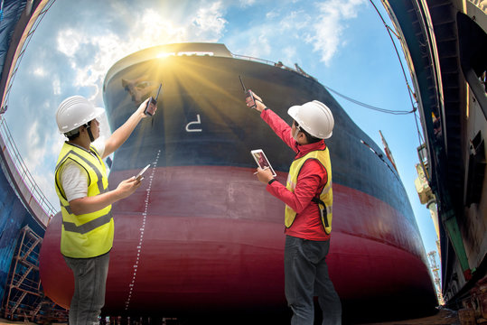 inspector, surveyor, port control or engineering and supervisor in review of the condition of the commercial ship bulk head after repainting recondition in dry dock yard, report, online.