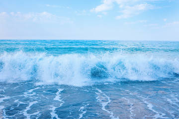 Naklejka na ściany i meble Beautiful view of splashing blue waves near the beach.