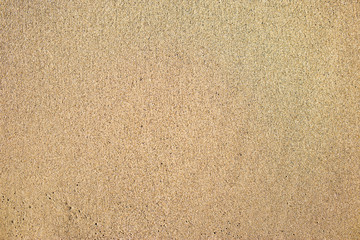 Top view of seashore, clean sand texture of natural surface.