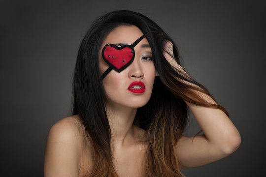 Portrait of beautiful woman with heart shape eye patch