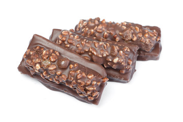 Small chocolate covered cakes with crushed nuts