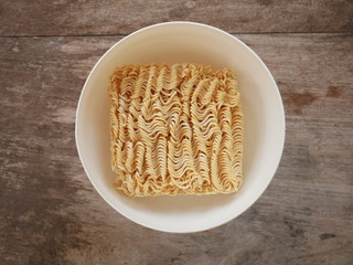 Quick cooking noodle is one on a wood background
