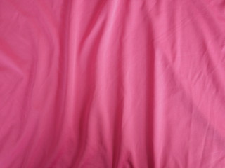 Fototapeta premium red silk fabric background, cotton cloth texture, pink sportswear