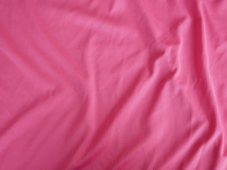 Fototapeta premium red silk fabric background, cotton cloth texture, pink sportswear
