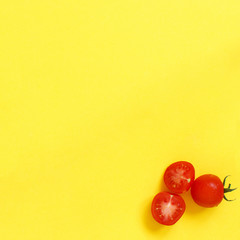 Cherry tomatoes on a yellow background