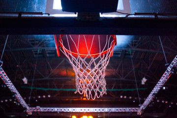 Obraz na płótnie Canvas basketball hoop in red neon lights in sports arena during game