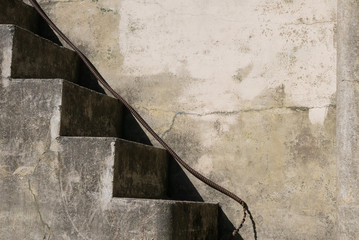 Grungy, cement staircase with blank wall