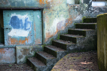 grungy, textured wall with painted surface and staircase