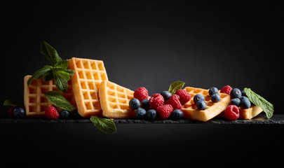 Waffles with  blueberries, raspberries  and fresh mint. - obrazy, fototapety, plakaty