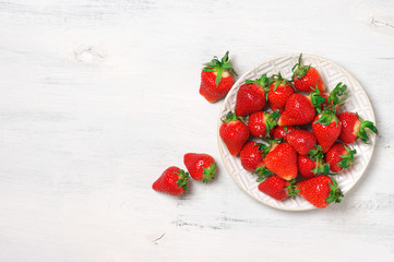 Fresh strawberries in plate on white wood - 263631082