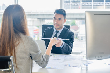CFO or chief financial officer sees financial summary reports with his secretary and discusses about future growth and improvements