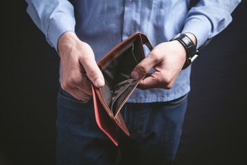Man holding empty wallet. Crisis