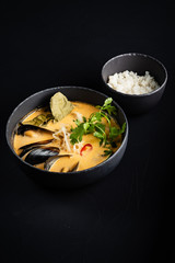 seafood soup and rice on the black background