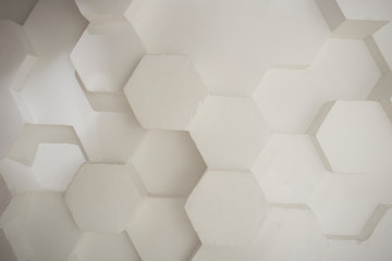 wall background. background texture. wall with textured hexagons. the diamonds on the wall. white...