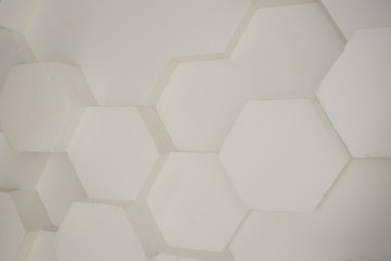 wall background. background texture. wall with textured hexagons. the diamonds on the wall. white wall