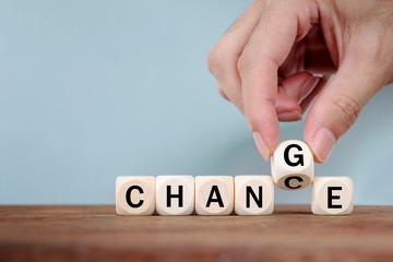 Hand Changing word from CHANGE  to GHANCE On Wooden Cube