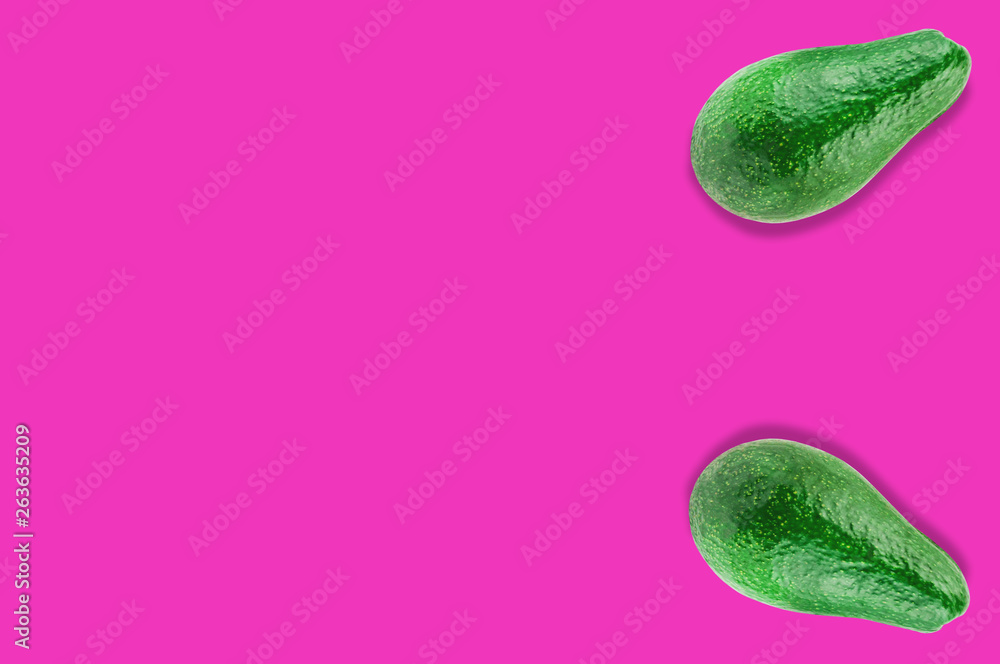 Wall mural pair of green whole fresh raw avocados on pink background with copy space for your text