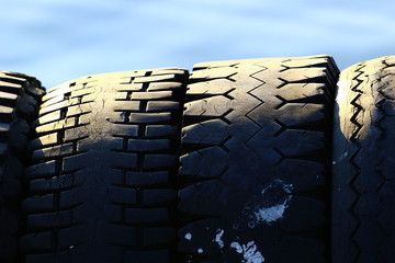 tires in port with used rubber and strong sun