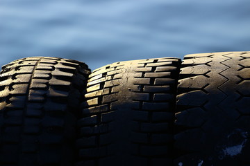 tires in port with used rubber and strong sun