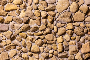 Wall decorated with stone, for background or texture, closeup wall built with natural stone, beautiful pattern and modern style