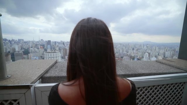 Slow Motion: Woman Looking Out Over City in Sao Paulo, Brazil