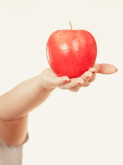 Woman hand holding red apple