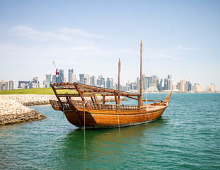 Fototapeta na wymiar Dhow Boat At The MIA Lake with Doha City Center on the Background