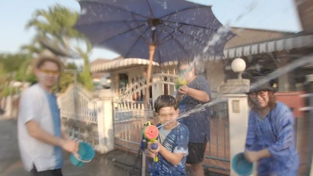 Slow motion people happy play splash water war celebration Songkran festival - local Chiang mai Thailand people in holiday traditional new year Songkran festival concept