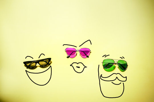 Funny happy family wearing sunglasses; mother, father with beard and a kid enjoying together concept