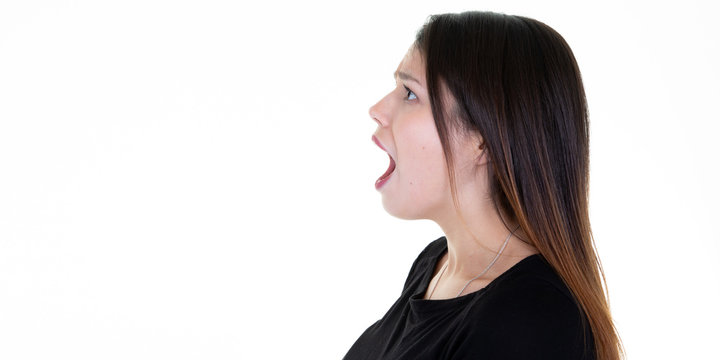 Closeup side view profile portrait young woman talking yelling with open mouth