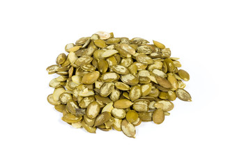 Pile of the peeled pumpkin seeds on a white background