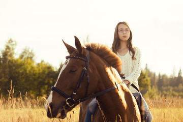 Fototapeta premium Young girl on the sorrel horse