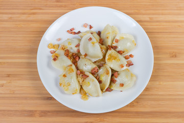 Cooked filled dumplings flavored with fried bacon and onion