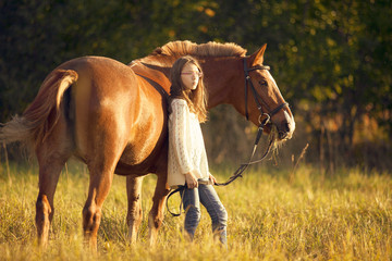 Young girl with horse in field