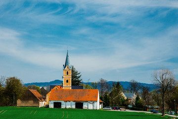 Old christian countryside church with mountains and blue sky