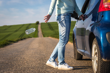 Irresponsible driver throwing water bottle on road