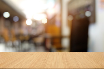 Empty dark wooden table in front of abstract blurred bokeh background of restaurant . can be used for display or montage your products.Mock up for space.